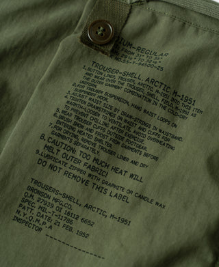 Olive shell arctic trousers with printed care label on inner waistband