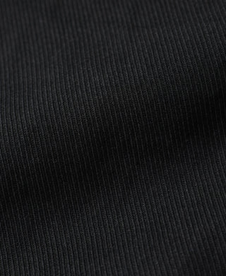 Black ribbed fabric texture panel on riding breeches