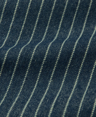 Indigo Wabash work shirt fabric close-up with fine light vertical pinstripes.