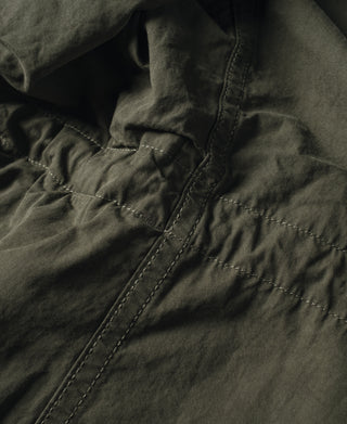 Olive field jacket pocket flap and stitched seam detail