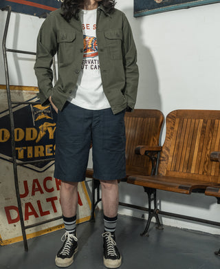Olive fatigue utility shirt with button front and two chest flap pockets