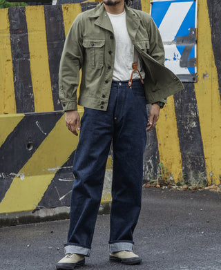 Olive fatigue jacket worn by model with chest flap pockets and button front