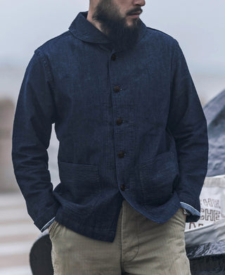 Indigo denim utility jacket worn by model, button front and flap pockets