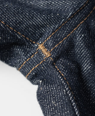 Dark denim jeans with tan stitched seam and curved pocket-edge stitching detail