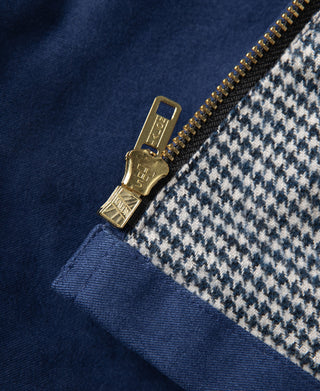 Blue cossack jacket zipper with brass pull and houndstooth-lined edge