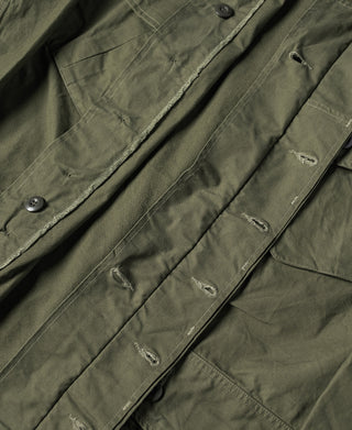 Olive fatigue jacket with chest pockets, snap buttons, and buttoned placket