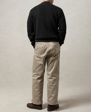 Black wool crewneck sweater worn on model, back view with ribbed hem