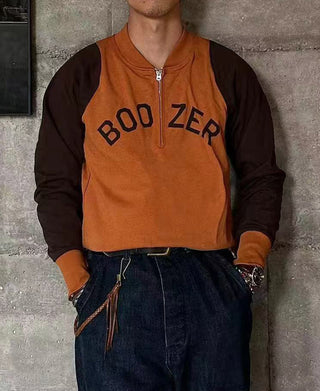 Orange quarter-zip long-sleeve T-shirt with dark sleeves and “BOO ZER” chest graphic