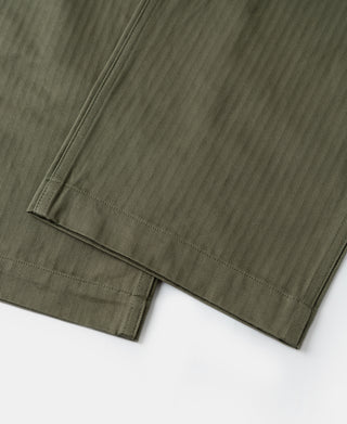 Olive trousers hem with double-stitched cuff and neat bottom edge