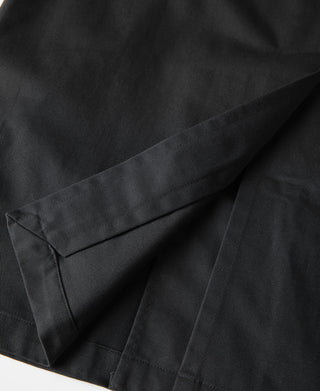 Black all-weather trench coat, front flap and welt pocket seam details