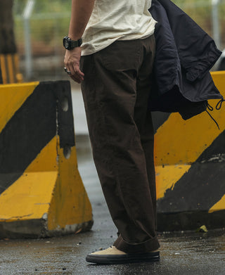 Dark brown combat pants with side pockets and relaxed straight-leg silhouette