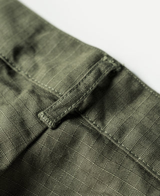 Olive fatigue pants hem close-up with stitched cuff and interior drawstring