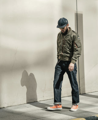 Olive flight jacket side view with arm patch and ribbed sleeve cuff