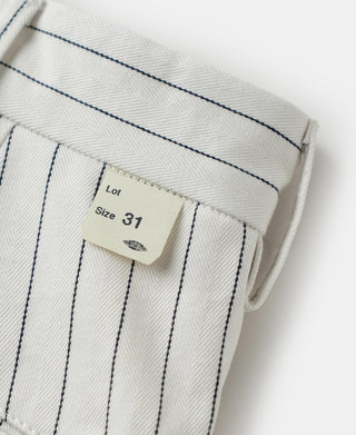 White striped work pants side pocket with fabric drape and size tag