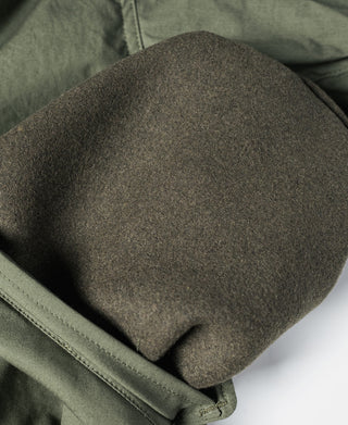 Olive M-65 parka sleeve cuff with gray knit lining at the opening