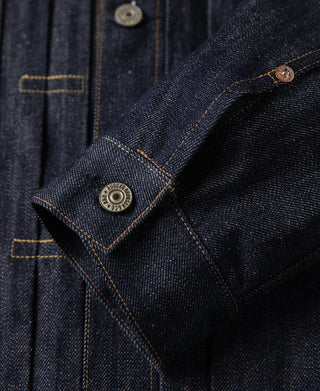Indigo denim jacket sleeve cuff with button tab and metal snap detail