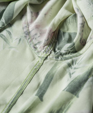 Light green aloha shirt with V-split neckline and short sleeves, tropical print