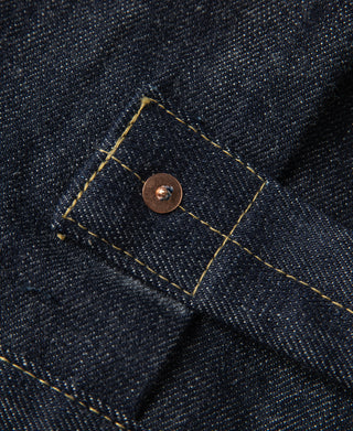 Indigo denim jacket pocket flap with brown button and yellow edge stitching