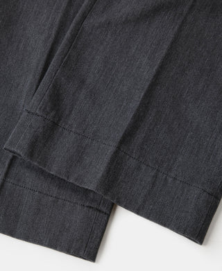 Dark gray chino trouser cuff with stitched hem and crease