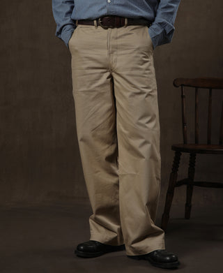 Tan chino trousers worn with blue shirt and black shoes