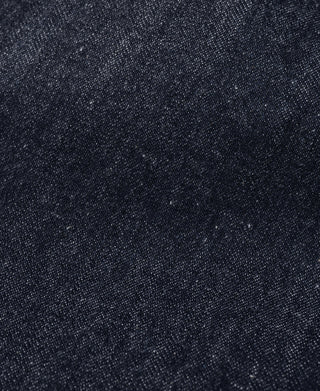 Close-up of dark navy denim fabric texture with fine woven pattern