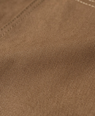 Khaki canvas hunting vest fabric texture with stitched seam lines