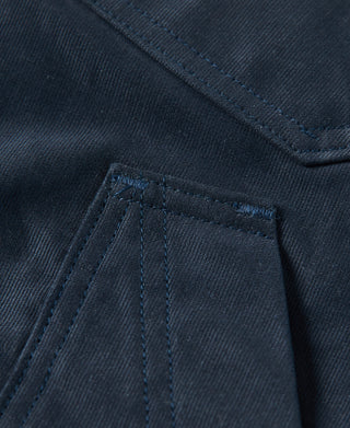 Navy deck pants pocket close-up with vertical stitch lines and reinforced edges