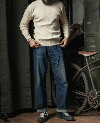 Apricot ribbed henley long-sleeve shirt worn with blue jeans, front view