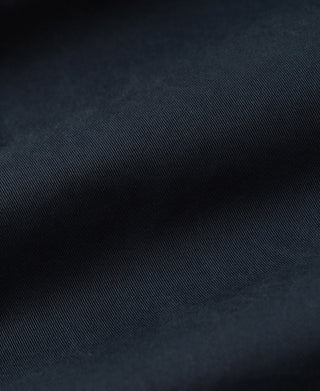 Close-up of dark navy cotton twill fabric texture.