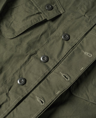 Olive utility jacket with row of snap buttons and cargo-style pocket detailing