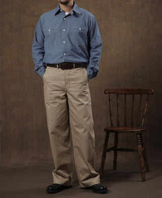 Blue chambray button-up work shirt with chest pockets and button cuffs
