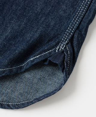 Indigo denim work shirt hem, curved edge with pocket opening and stitching