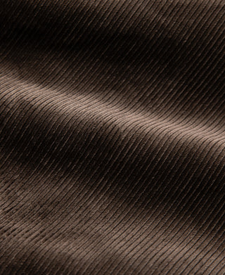 Brown corduroy fabric close-up with fine ribbed texture