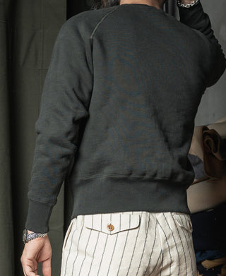 Dark back view of raglan crewneck sweater with ribbed hem