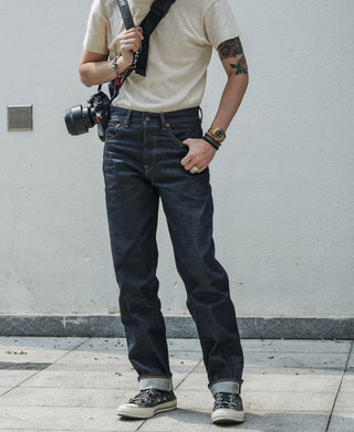 Indigo denim jeans on model, straight fit with belt loops and front pockets