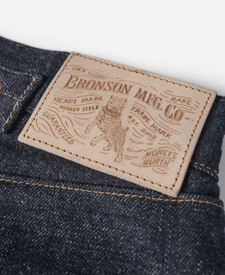 Indigo selvedge denim jeans—tan leather brand label on waistband