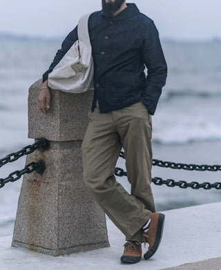 Indigo denim utility jacket on model, stand collar and buttoned chest placket