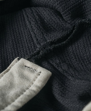 Inner waistband and side label area of dark striped pants
