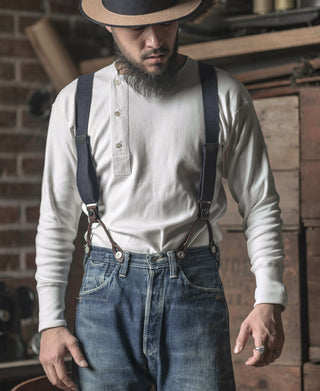 White henley shirt with three-button neckline placket worn with jeans