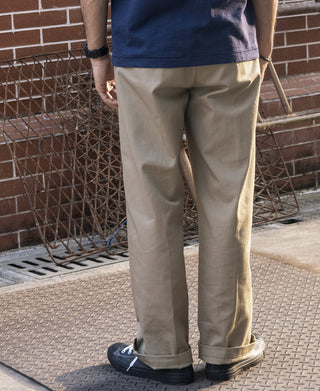 Khaki straight-leg work pants with belt loops and stitched seams, full length