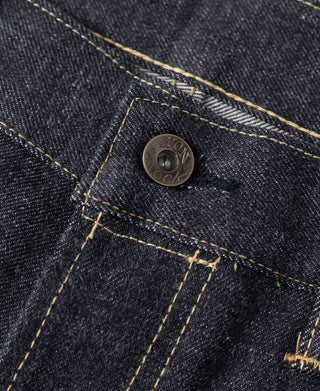 Selvedge denim jeans coin pocket with round logo button and contrast yellow thread