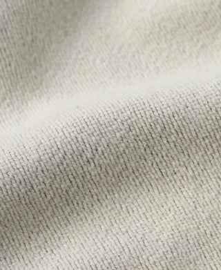 Light gray hooded sweatshirt fabric closeup with textured knit surface