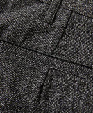 Salt-and-pepper trousers front pocket and crease detail