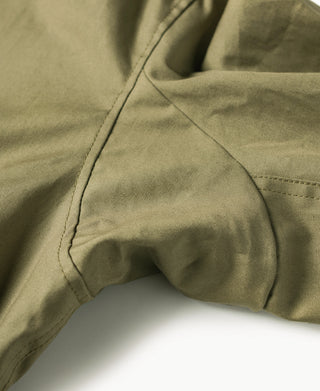 Olive field jacket sleeve cuff area with shaped pocket opening