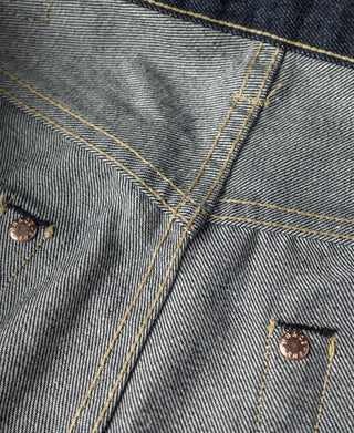 Indigo selvedge denim jeans, front yoke seam with copper buttons and stitched placket