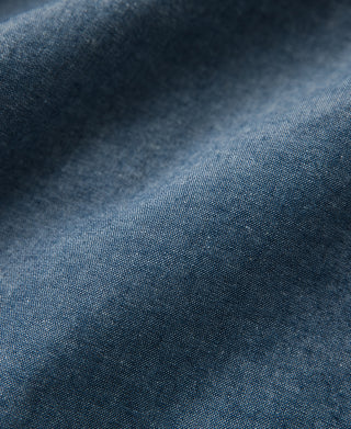 Blue chambray work shirt fabric texture close-up