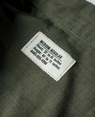 Olive fatigue jacket inside size label: Medium Regular