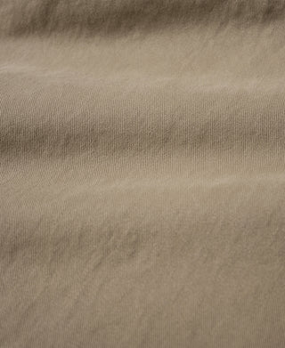Khaki cotton trousers fabric close-up with visible weave texture