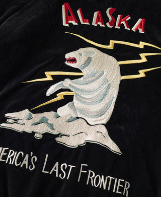 Red “ALASKA” lettering above embroidered animal graphic on black jacket