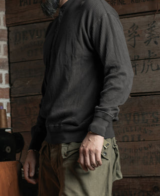 Black ribbed long-sleeve henley shirt, side view with cuffs and hem